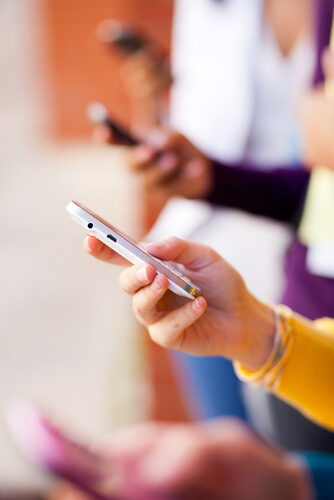 Side view of a hand holding a smartphone.