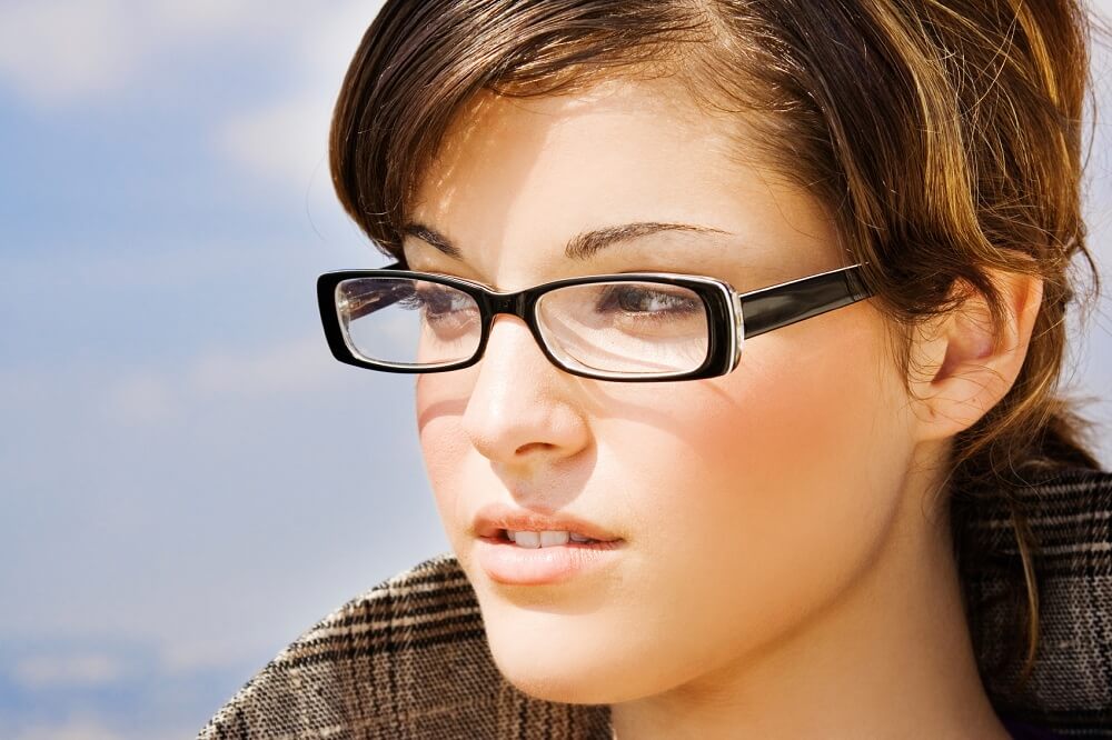 Portrait of a person in plastic framed glasses.