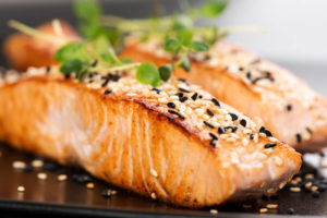 2 filets of salmon with sesame seeds, and some cilantro atop that.