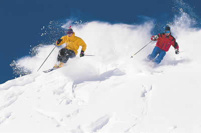 Two people skiing on a mountain