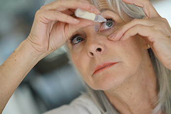 Glaucoma Buckhead Woman Putting in Eye Drops for Glaucoma