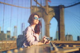 Woman on a bridge with camera