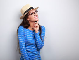 Young trendy woman wearing glasses and a hat