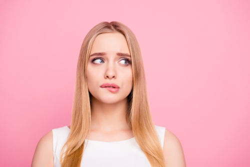 Woman making a face looking away