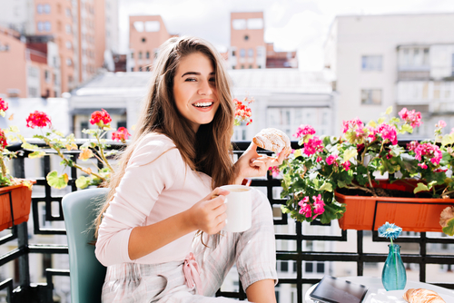 Woman with coffee and breakfast pastry