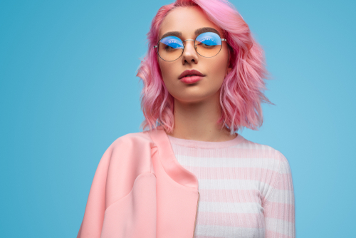 Trendy woman with pink hair and glasses