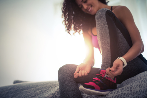 Athletic woman tying her shoe