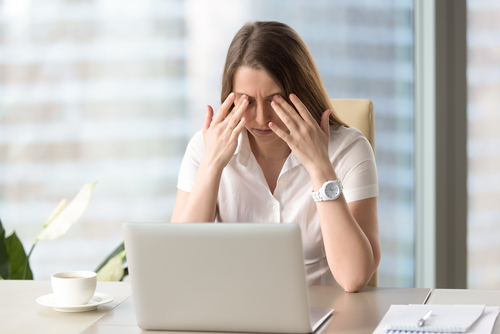 Woman rubbing her irritated eyes