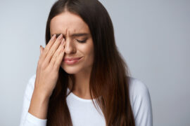 Woman rubbing her irritated eyes