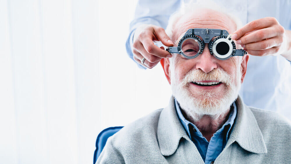 Older man having eye exam done