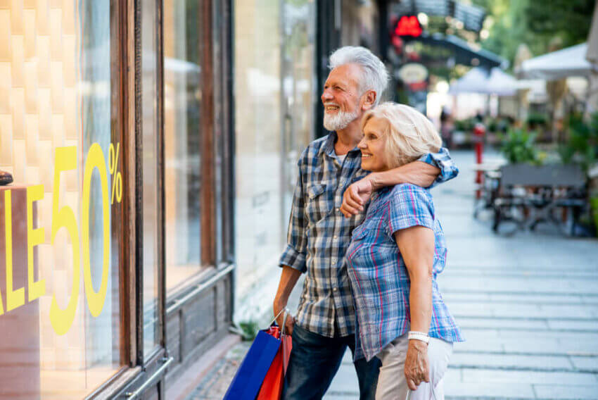 Happy older couple window shopping