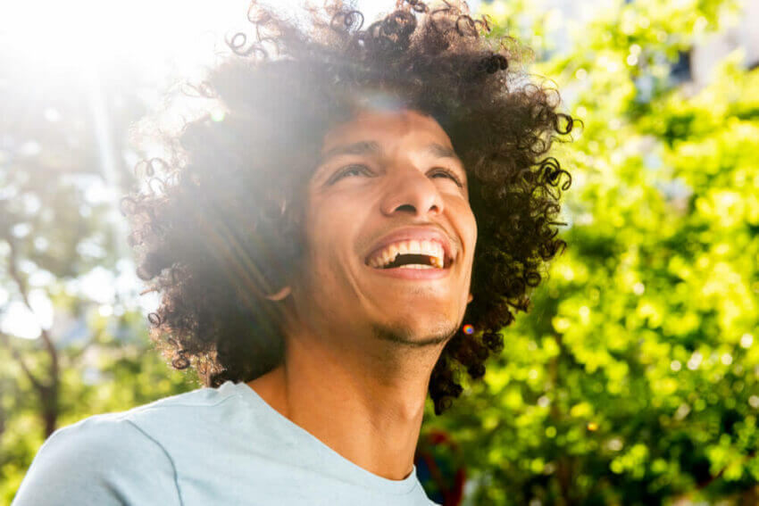 Smiling man outside in the sun